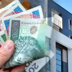 Dłoń trzyma polskie banknoty, symbolizujące kredyt na wkład własny na zakup nowoczesnego mieszkania.