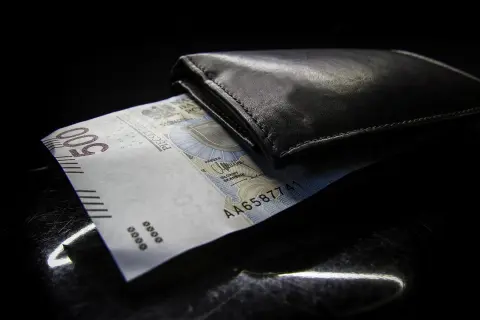 Czarna portmonetka z banknotem 500 zł. Zastanawiasz się, jaki suma limitów kredytowych co wpisać?